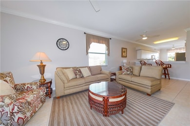 Living area featuring ceiling fan, crown molding,