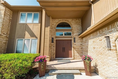 Property entrance with brick siding and a patio area