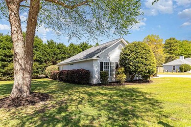View of side of property with a lawn
