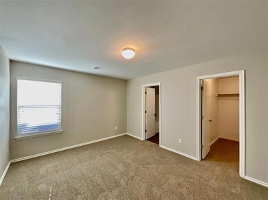 Unfurnished bedroom featuring a walk in closet, a 