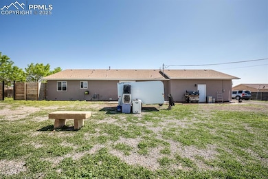 Rear view of property featuring stucco siding