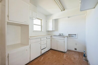 Kitchen with light countertops, a sink, and white 