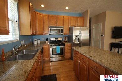 Features quartz counter tops, large center island with some pull out's in the cabinets.   There is a trash and recycle bin built into the cabinets.