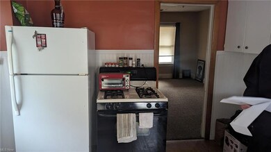 Kitchen with white appliances and wood-type flooring