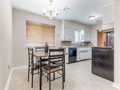 Kitchen with light tile flooring, pendant lighting