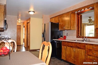 Looking through the kitchen toward the entrance, y