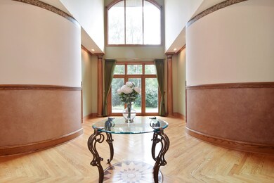 Bright 2-story foyer.View front front door of foye