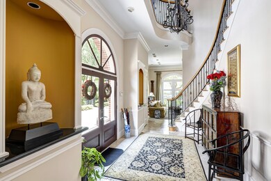 Dramatic two-story entry featuring art niches and