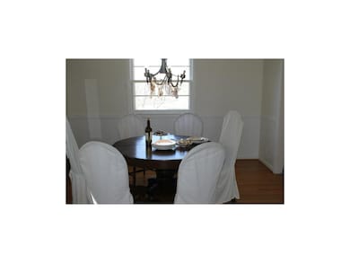 Kitschy formal dining room with chandelier and har