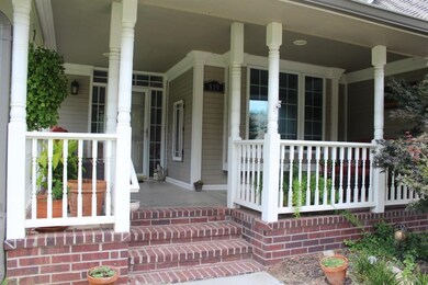 Fancy entrance to this home with a front balcony t