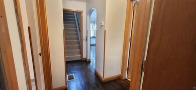 Corridor featuring dark wood-type flooring