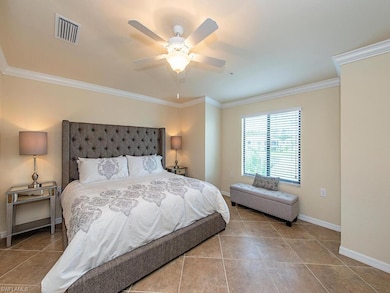 Dining space featuring crown molding, light tile p