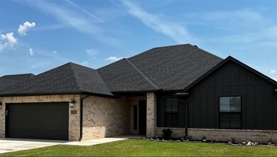 View of front of property with a garage and a fron