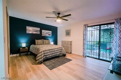 Bedroom with wood finished floors, access to exter