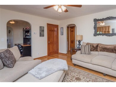 Large living room with hardwood floors, wood trim,
