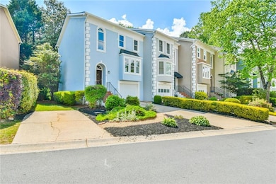 View of property featuring stairs, a garage, and s