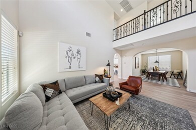 Living room with arched walkways, wood finished fl