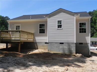 Rear view of house featuring a wooden deck