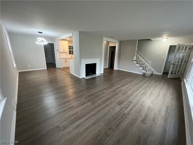 Unfurnished living room featuring dark hardwood / wood-style floors