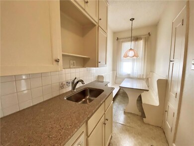 Kitchen with a sink, tasteful backsplash, decorat
