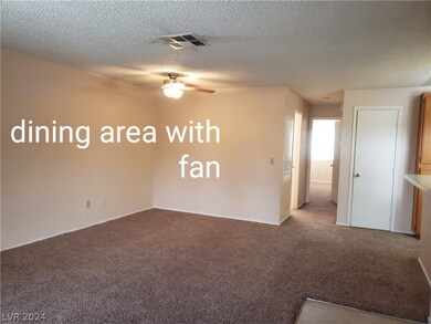 The dining area has a ceiling fan with light.