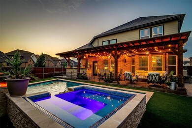 Pool at dusk with an in ground hot tub, a patio area, a lawn, a pergola, and an outdoor living space