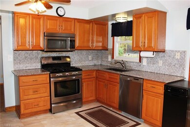 Granite counter tops and tile back splash enhance 