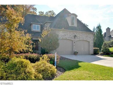 Exterior Front. What a beautiful brick home located in desirable Grandover community