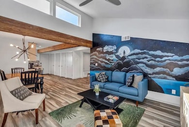 Living room with wood finished floors, visible ve