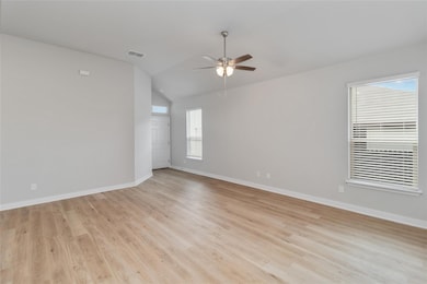Empty room with vaulted ceiling, visible vents, l