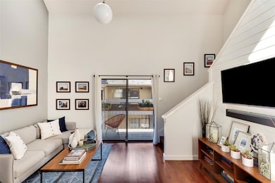 Living room with stairway and hardwood / wood-sty