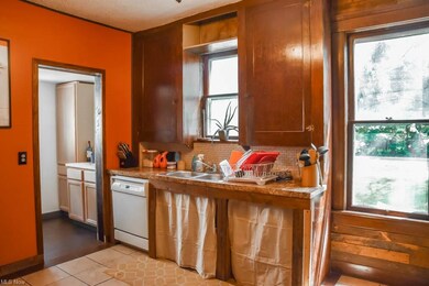 The kitchen has a dishwasher and tile flooring.