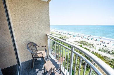 Balcony with a water view and a beach view