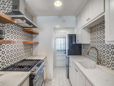 Kitchen with a sink, open shelves, wall chimney ex