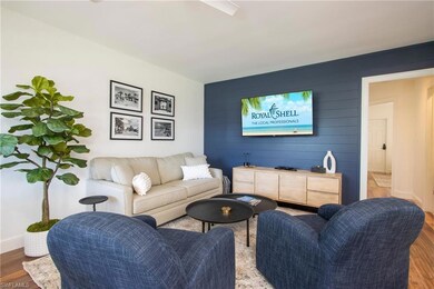Living area with ceiling fan, wood finished floors, and baseboards