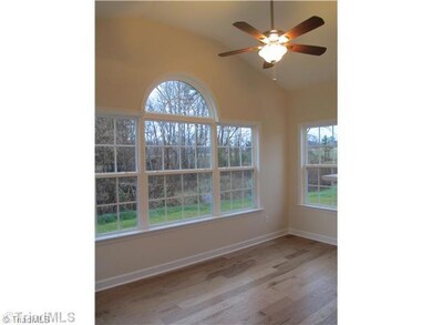 Sunroom. SIMILAR PHOTO - this is OPTIONAL sunroom shown here in Lot 5.  Lots of natural light, vaulted ceiling, double sided fireplace & access to patio!  (call LA for pricing details)