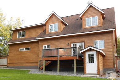 Back of home with large fenced yard