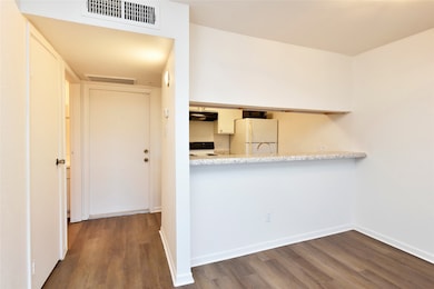 A cozy entryway with leading into kitchen area. Th