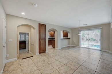 Spare room with arched walkways, light tile patter