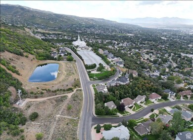 Aerial overview of property's location with a water and mountain view and nearby suburban area