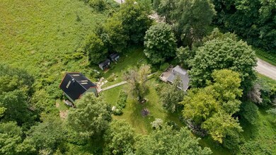 View of studio, storage sheds, house, deck and gar