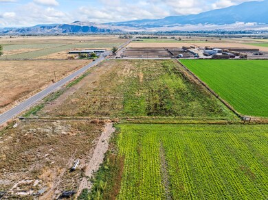 View of rural area featuring mountains and farmland