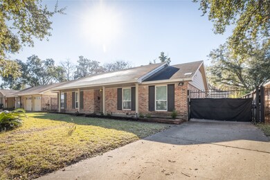 Spacious driveway with gated side access, perfect for additional parking or securing outdoor storage.