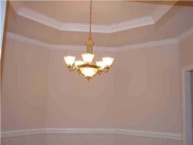 Formal dining room with gleaming hardwood floors.