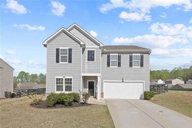 View of front of home featuring a garage, board and batten siding, and driveway