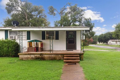 View of front of house featuring a front lawn and covered porch