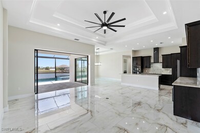 Unfurnished living room featuring a tray ceiling,