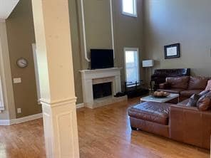 Living area with a fireplace with raised hearth, a