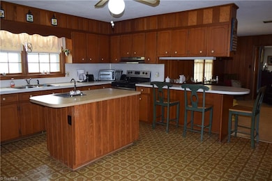 Kitchen island with 2nd sink and a breakfast bar.