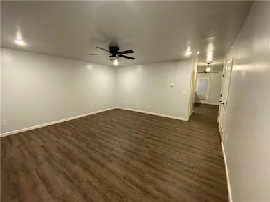 Spare room featuring ceiling fan and dark wood finished floors